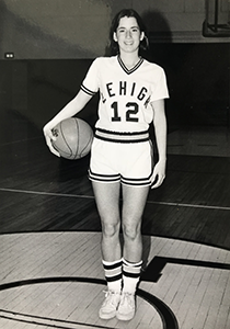 Cathy Engelbert '86 poses in her Lehigh basketball uniform with a basketball against her hip during her time at Lehigh University